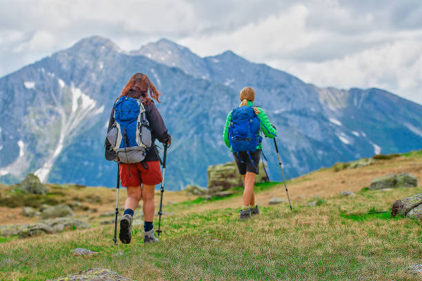 istock Two female friends during a mountain excursion 971340868