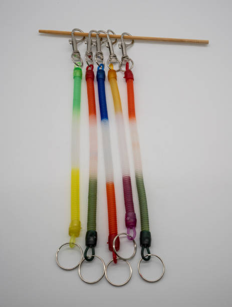 istock Colorful key chain ring and silver metal hook with strecthable spiral string isolated on white background. 971344190