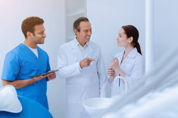 istock Professional stomatologist talking to his assistants 971344730