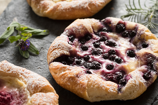 Blueberry and raspberry custard pastries on slate serving tray.\n\nCreativeContentBrief 700041353: Cozy Home Moments\nCreativeContentBrief 663926717: Regional Food Elements & Backgrounds