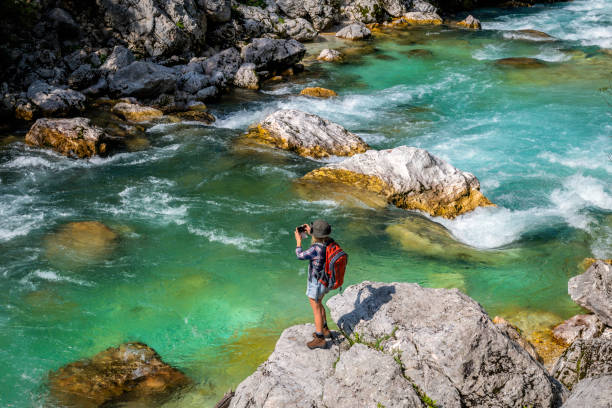 The young woman enjoys the river Soča, Trenta valley, Primorska, Slovenia, Europe The young woman enjoys the river Soča, Trenta valley, Primorska, Slovenia, Europe,no logos,Nikon D850 soca valley stock pictures, royalty-free photos & images