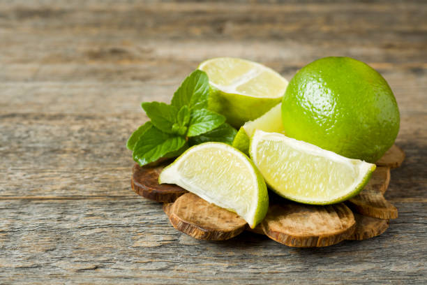 istock Fresh citrus lime mint berries on wooden background. Copy space for text 971350960