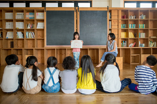 Young school girl giving a presentation in class. Okayama, Japan