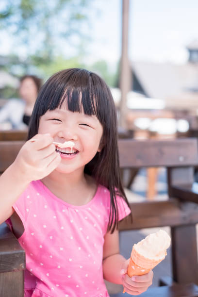 istock cute girl eat ice cream 971370646