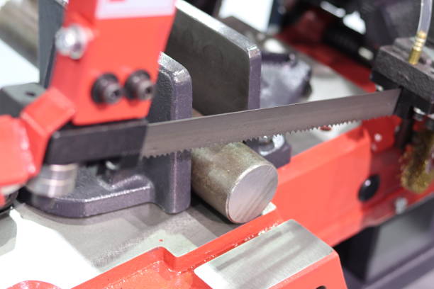 istock Steel bar cutting by band saw machine 971373724