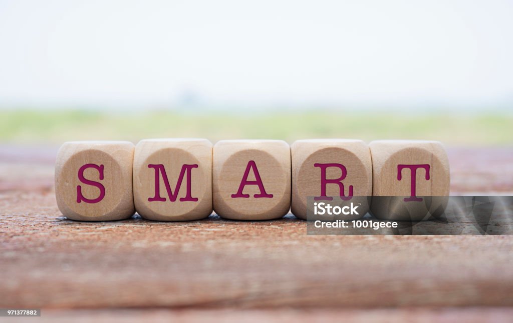 Smart word written on cube shape wooden blocks on wooden table. Intelligence Stock Photo