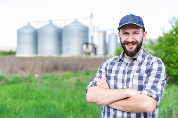 istock Farmer standing in front of silos 971380946