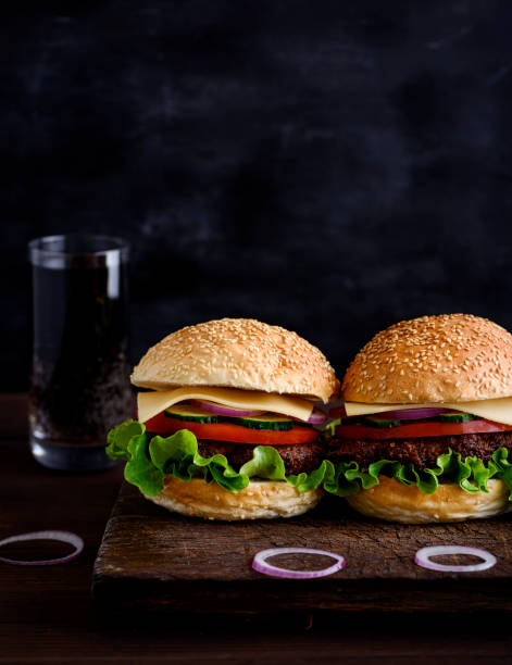 istock two burger with meat, vegetables and cheese 971381270