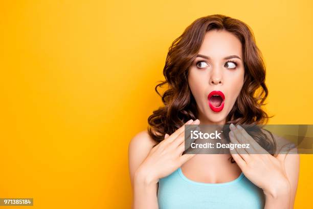 Portrait With Copy Space For Advertisement Of Shocked Afraid Woman Looking With Eyes At Empty Place Having Wide Open Mouth Eyes Gesturing Palms Isolated On Yellow Background Stock Photo - Download Image Now