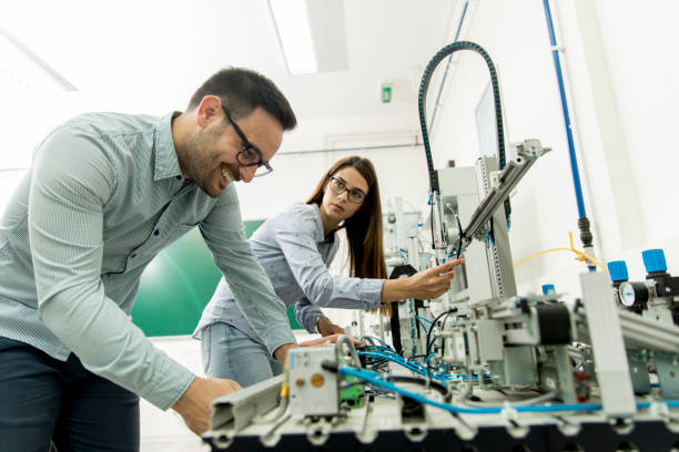 istock Young couple of students working at robotics lab 971388080
