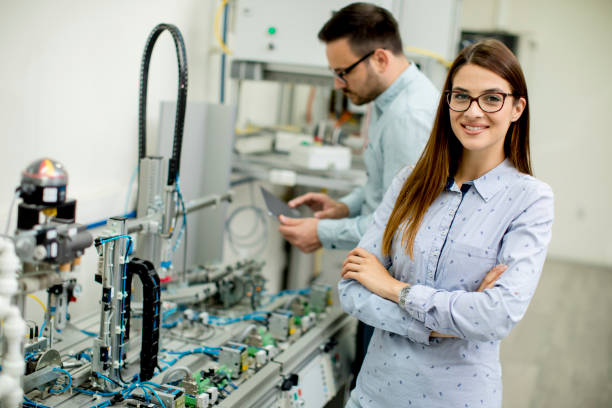 istock Young couple of students working at robotics lab 971388086