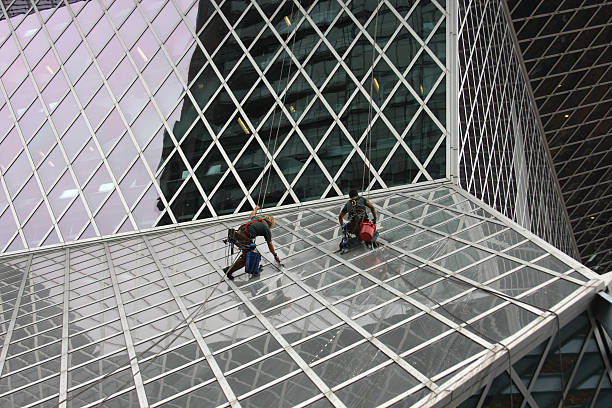 Men Cleaning A Glass Building stock photo