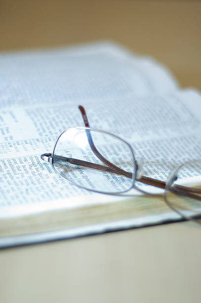 Opened Book/Bible and Eye Glasses stock photo