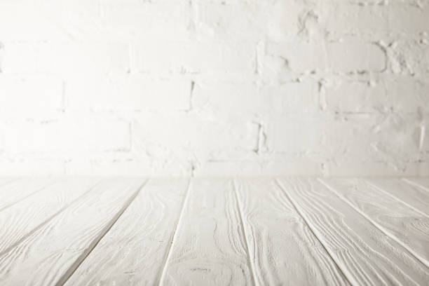 istock white wooden tabletop and white wall with bricks 971396108
