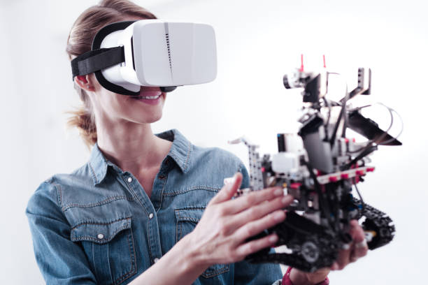 istock Joyful nice woman holding a robot 971397142