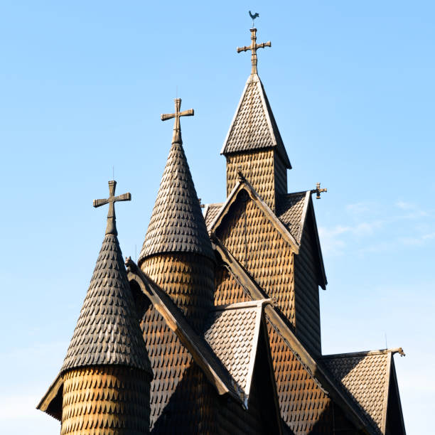 Towers on Heddal stave church The 13th century Heddal stave church on a sunny day. Details of the church towers with their wooden rooftiles. This is the biggest stave church in Norway. heddal stock pictures, royalty-free photos & images