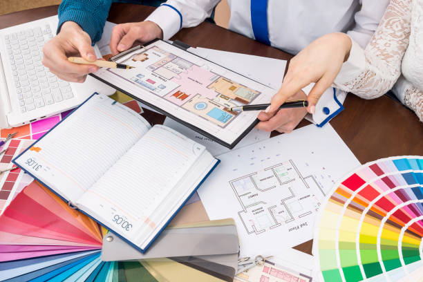istock Designers discussing house plan, renovation and colour sampler 971404406