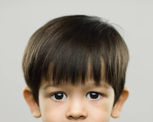 istock Halved portrait of real kid with blank expression 971409968