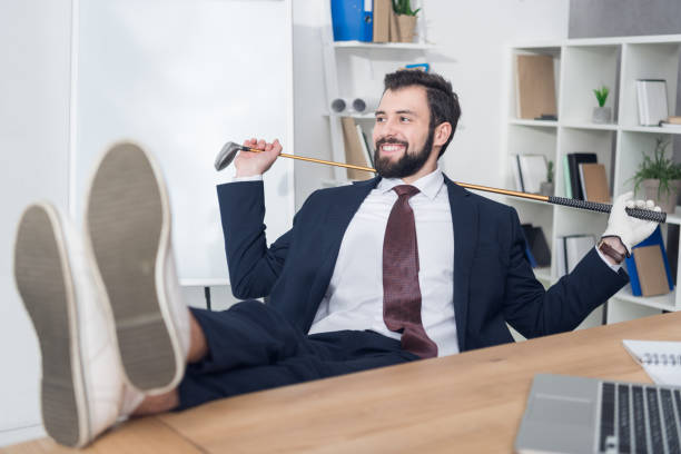 istock smiling businessman with golf equipment at workplace in office 971423250