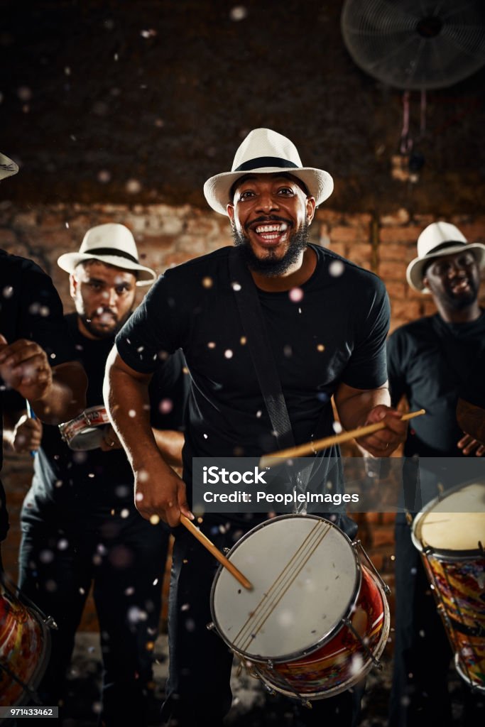 Their beats will keep you dancing all night long Portrait of a group of musical performers playing drums together Party - Social Event Stock Photo