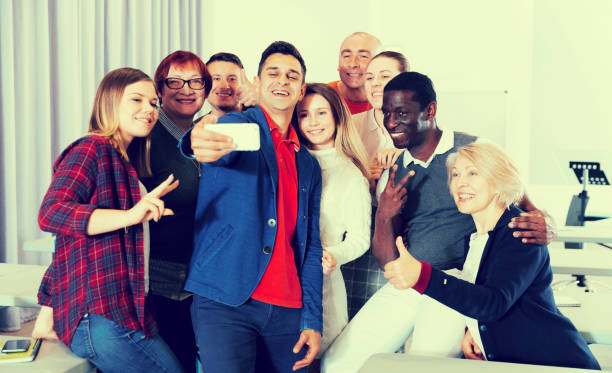 istock Adult students taking selfie in auditorium 971443858