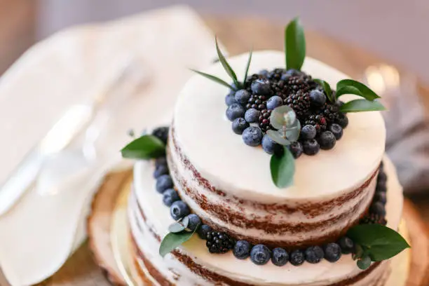 Photo of Wedding or birthday cake with berries. Sweet pie on banquet in restaurant.