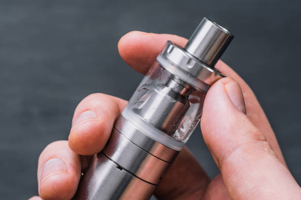 istock Vape young man vape electronic cigarette cloud by using a mod, smoke tricks of vaping device background. 971444440
