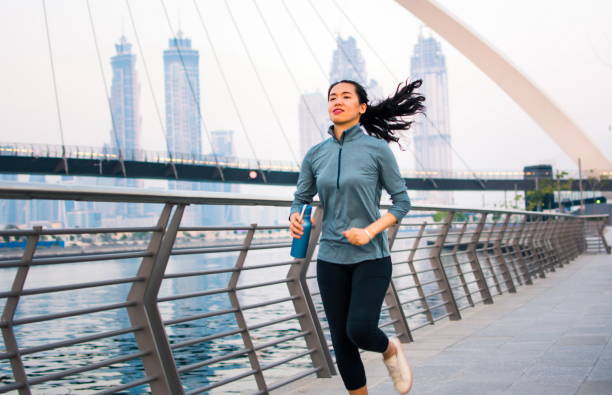 istock Girl running in a modern city environment 971448002