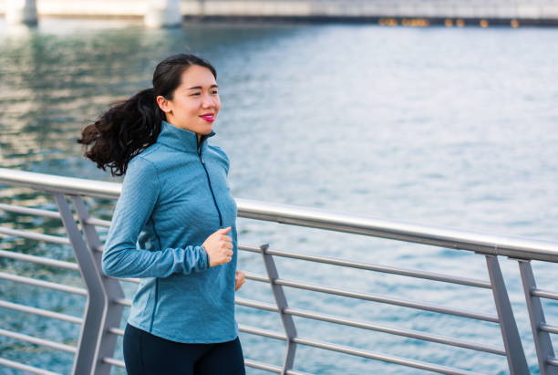 istock Girl running in a modern city environment 971448064