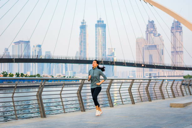 istock Girl running in a modern city environment 971448426