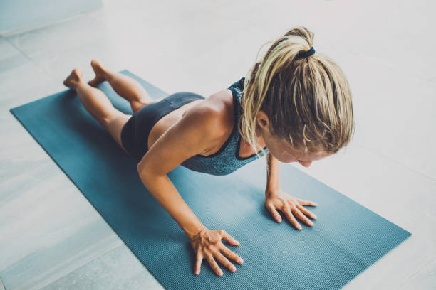istock Sporty woman doing exercise in a gym 971448682