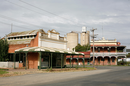 Horizontal railway station platform with red solar powered public community train awaiting passengers at Byron Bay North NSW Australia