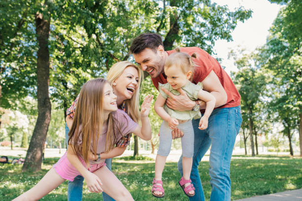 istock Happy parents holding their daughters 971500176