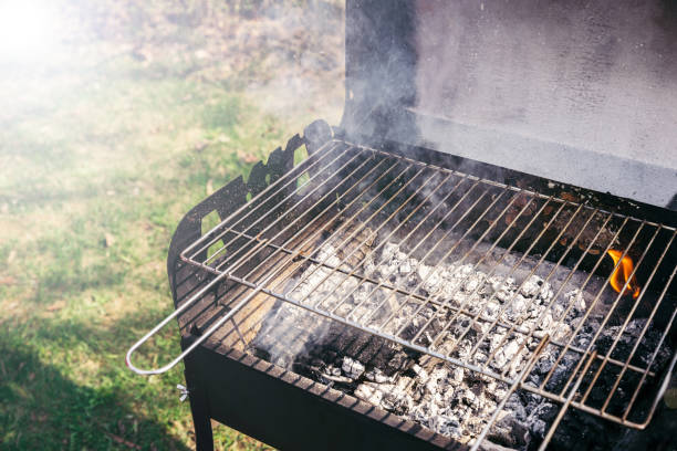 istock Grill with burning coals ready for barbecue outdoors 971500852