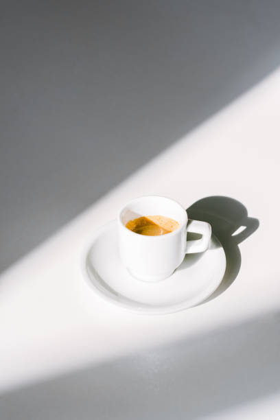 istock cup of tasty coffee in white cup on white surface 971503504