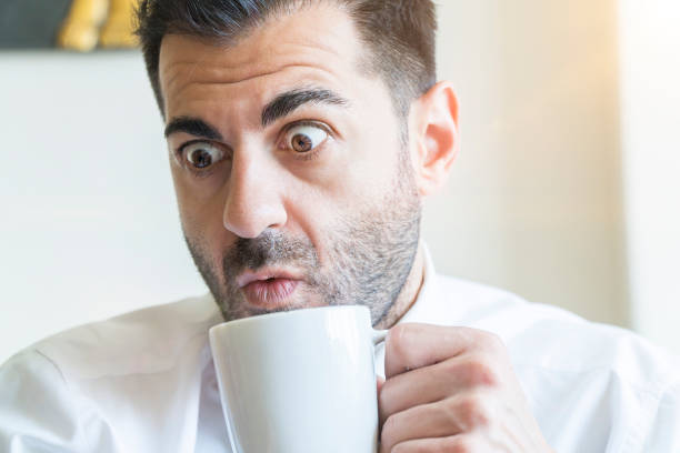 istock Businessman drinking coffee and suprising 971503870