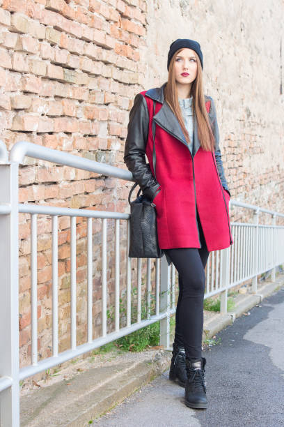 istock Young brunette in stylish winter coat posing 971504316