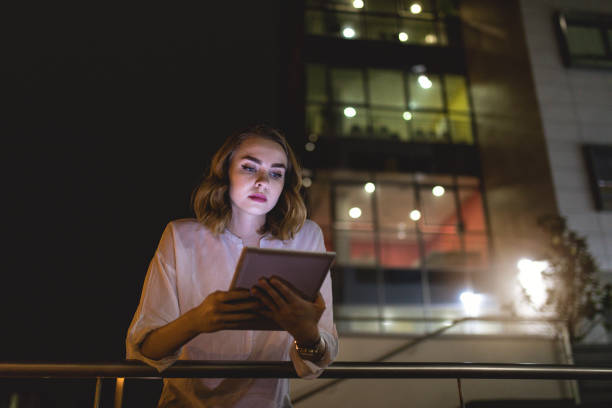 istock Businesswoman planning strategy outdoors at night 971507922