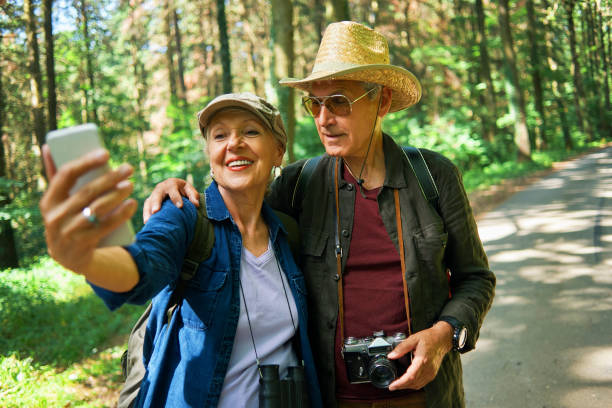 istock active seniors hikers taking a selfie in nature 971508186