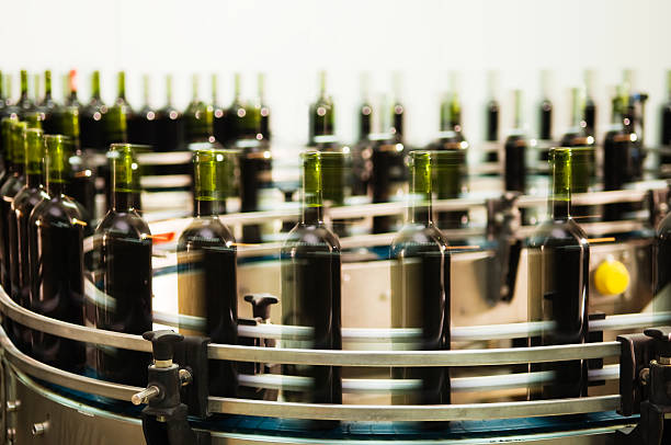 Bottle filling line Turntable of a bottle filling line at a modern winery bottling plant stock pictures, royalty-free photos & images