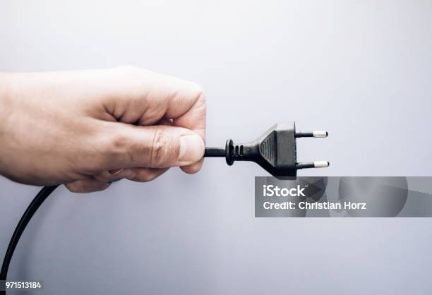 Male Hand Holding Electric Plug Stock Photo - Download Image Now - Electric Plug, Power Cable, Electricity