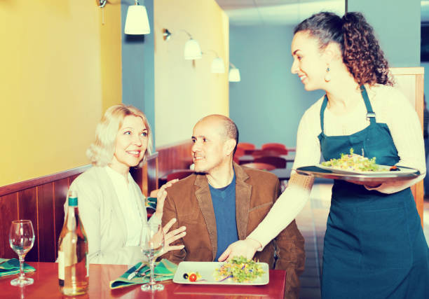 istock Waitress serving senior customers 971514474