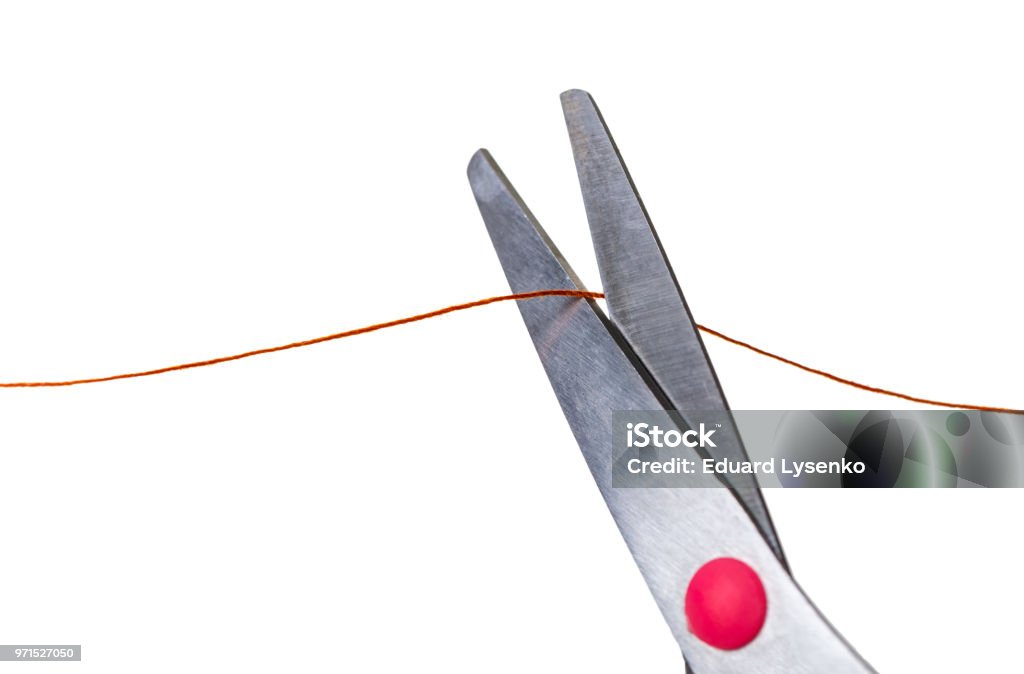 scissors cut the thread scissors cut the thread on a white isolated background Cutting Stock Photo