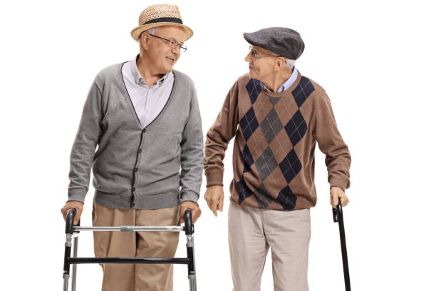 istock Elderly man with walker and another man with cane walking 971534276