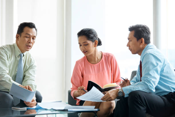 istock Business people discussing over document in office 971548382