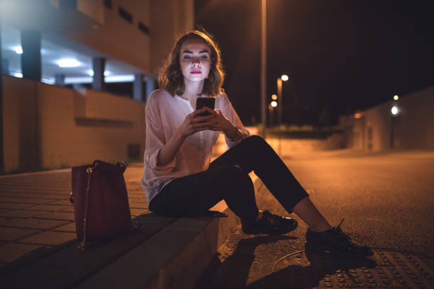 istock Overworked businesswoman sitting on a sidewalk 971552868