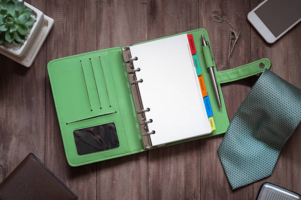 istock Blank notebook with gentleman accessories on woodle table, top view flat lay with copy space. 971575504