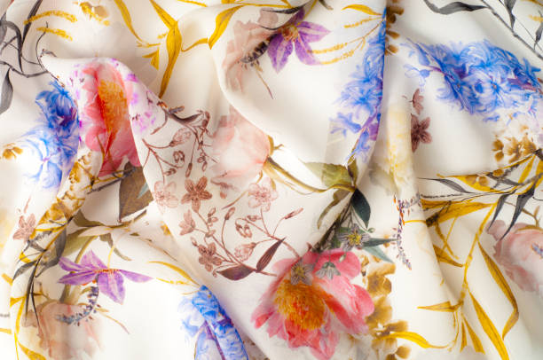 istock Texture, background, pattern. Silk fabric. Texture with pink and yellow flowers in watercolor technique. Wallpapers with roses, daisies and mimosa. Greeting card. Silk scarf, shawl. Holidays. 971583134