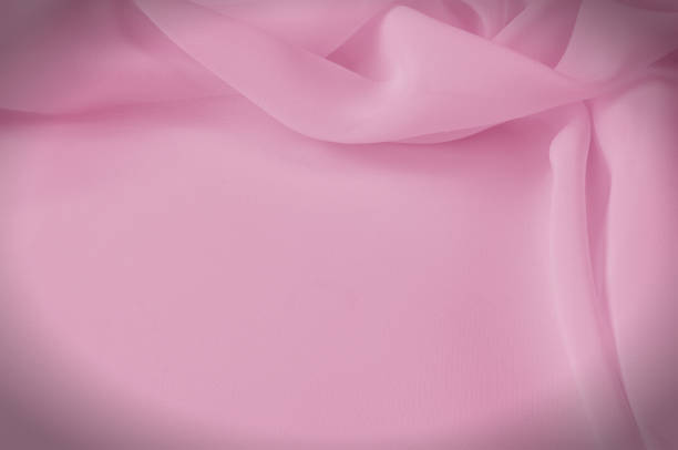 istock Texture, background, pattern. Silk fabric pale pink, abstract folds 971583454