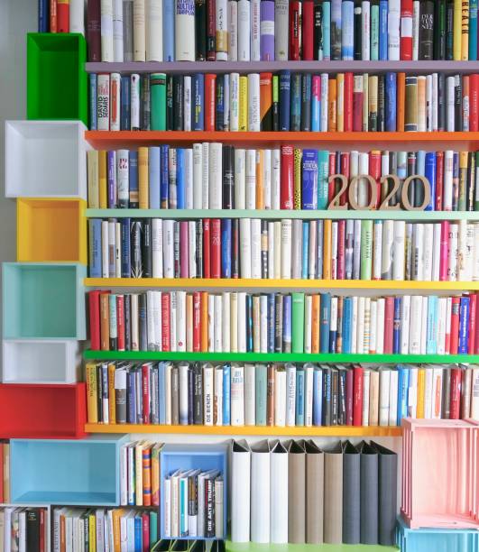 istock Year 2020 as wooden numbers standing on library shelf 971586596